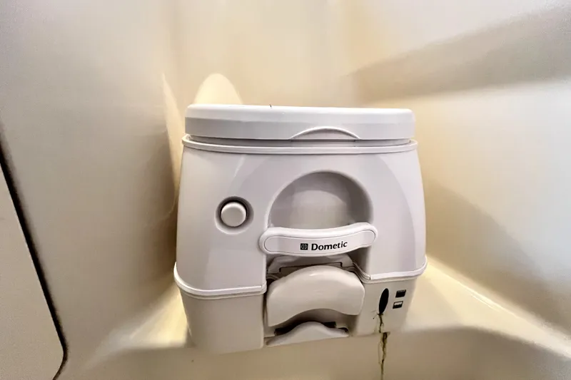 Slide: The Image of Dometic portable toilet in 2010 Sea Ray 240 Sundancer boat bathroom. - 70