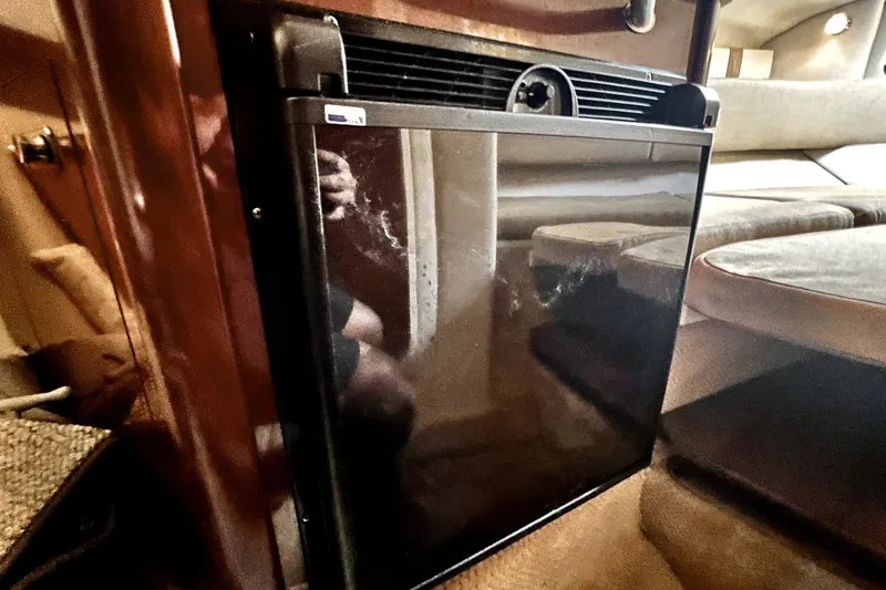 Slide: The Image of Interior of 2010 Sea Ray 240 Sundancer showing a compact refrigerator. - 68