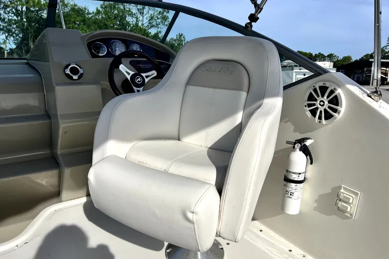 Slide: The Image of Captain's seat and dashboard of a 2010 Sea Ray 240 Sundancer boat. - 48
