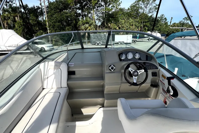 Slide: The Image of 2010 Sea Ray 240 Sundancer boat interior with steering wheel and seating. - 47