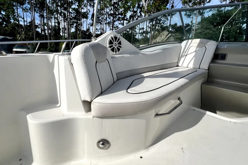 Slide: The Image of Interior seating of 2010 Sea Ray 240 Sundancer boat with white upholstery. - 49