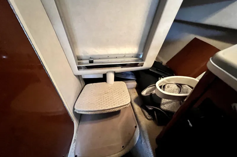 Slide: The Image of Interior cabin of 2010 Sea Ray 240 Sundancer boat, featuring seating and storage area. - 60