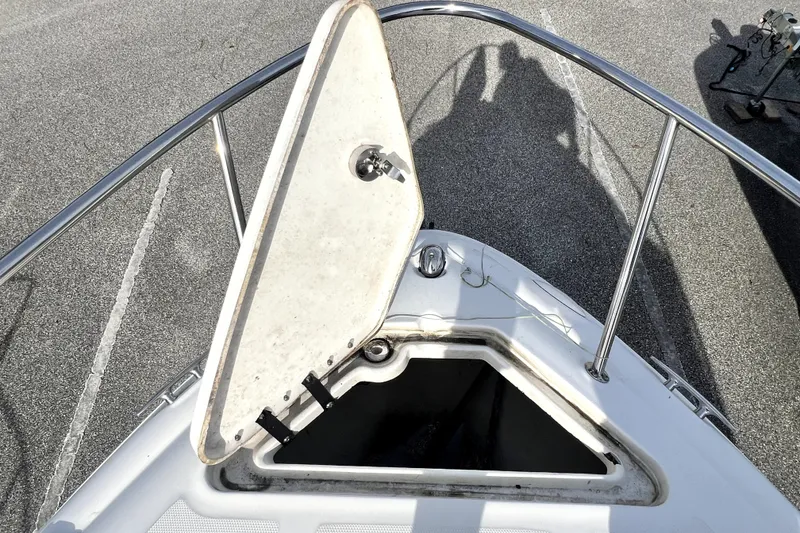 Slide: The Image of Open hatch on 2010 Sea Ray 240 Sundancer boat deck, showing interior compartment. - 37
