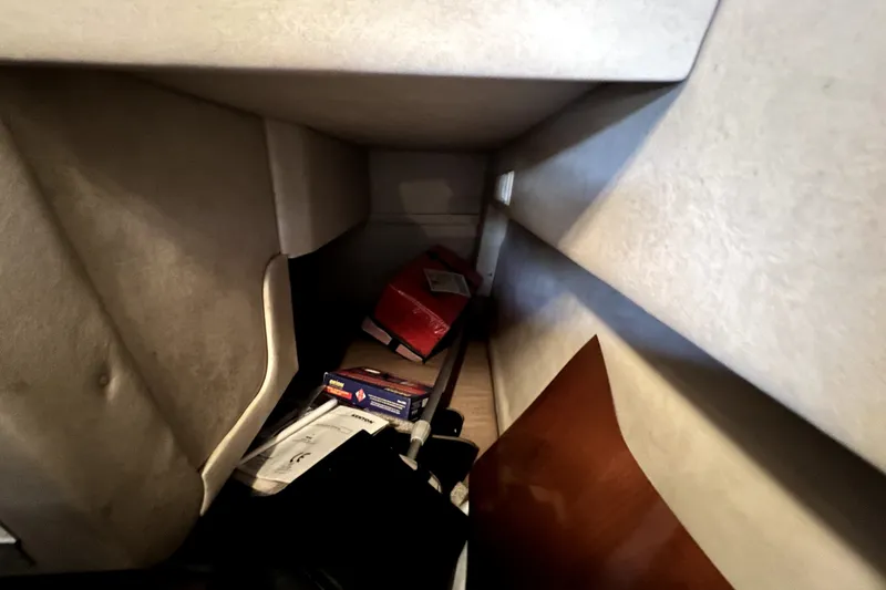 Slide: The Image of Interior storage area of a 2010 Sea Ray 240 Sundancer boat with miscellaneous items. - 58