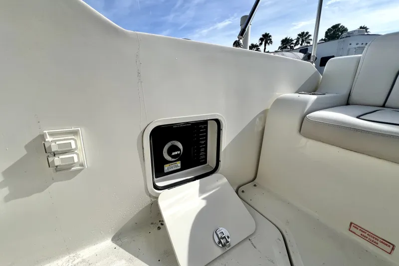 Slide: The Image of Interior view of a 2010 Sea Ray 240 Sundancer boat, featuring a control panel. - 85