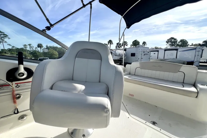 Slide: The Image of 2010 Sea Ray 240 Sundancer boat interior with helm seat and passenger bench. - 61