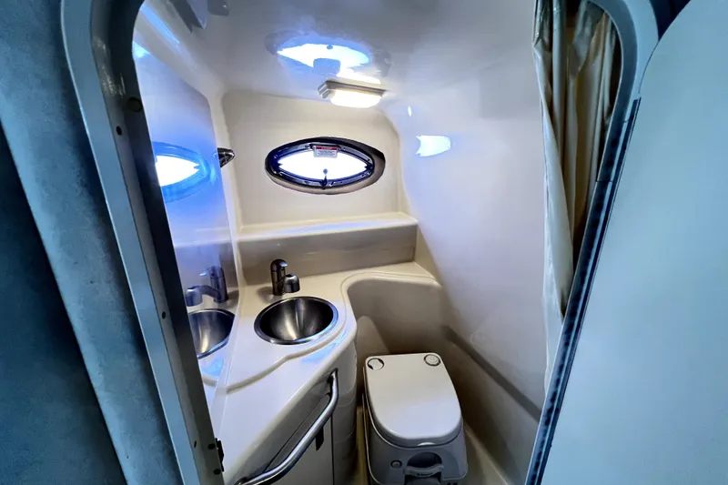 Slide: The Image of Compact bathroom in 2010 Sea Ray 240 Sundancer boat with sink and toilet. - 73