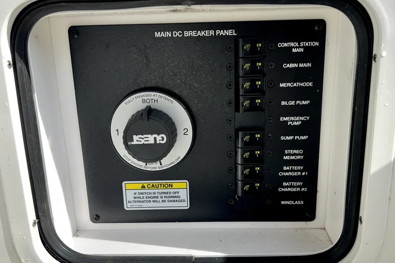 Slide: The Image of Main DC breaker panel on 2010 Sea Ray 240 Sundancer boat, featuring various switches and controls. - 84