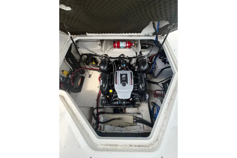 Slide: The Image of Engine compartment of a 2010 Sea Ray 240 Sundancer boat, featuring a MerCruiser engine. - 15