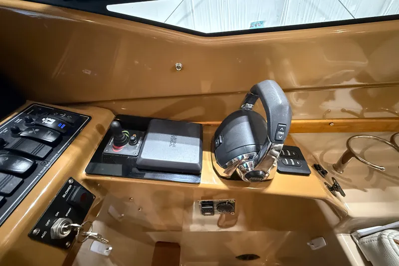 Slide: The Image of Helm controls of a 2016 Cutwater C-24 boat, featuring throttle and joystick. - 39