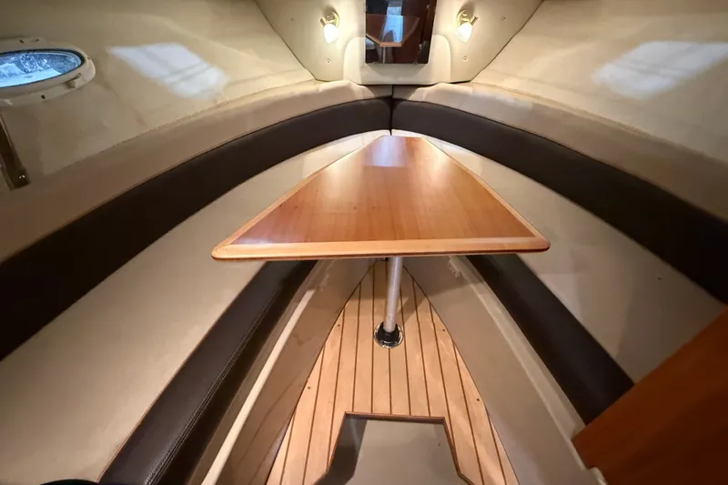 Slide: The Image of 2016 Cutwater C-24 cabin interior with wooden table and seating. - 26