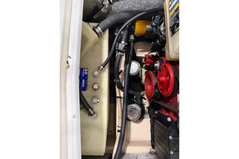 Slide: The Image of Engine compartment of a 2016 Cutwater C-24 boat, featuring hoses and mechanical components. - 42