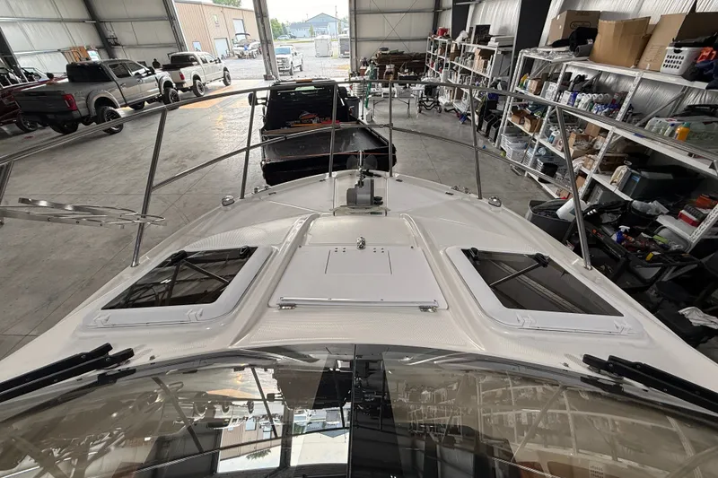 Slide: The Image of 2016 Cutwater C-24 boat in a garage, surrounded by trucks and shelves. - 8