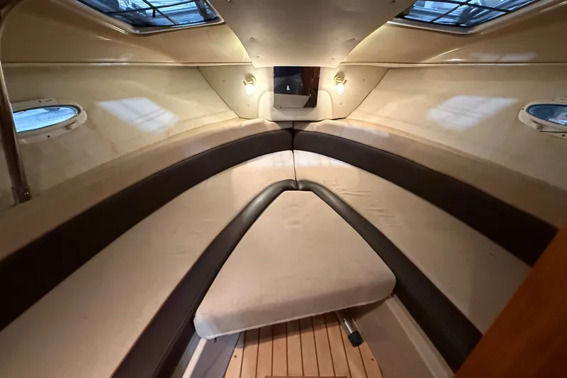 Slide: The Image of Interior cabin of a 2016 Cutwater C-24 boat, featuring cozy seating and ambient lighting. - 30