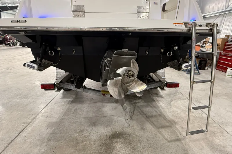 Slide: The Image of 2016 Cutwater C-24 boat stern with propeller and ladder in a garage setting. - 7
