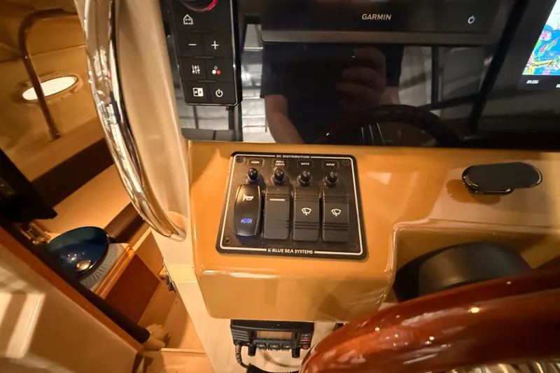 Slide: The Image of Control panel of a 2016 Cutwater C-24 boat with Garmin display and switches. - 37