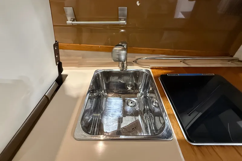 Slide: The Image of Stainless steel sink and stove in 2016 Cutwater C-24 boat kitchen. - 21