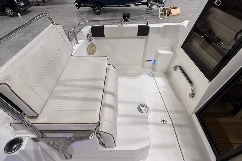 Slide: The Image of Interior view of a 2016 Cutwater C-24 boat, featuring a cushioned seating area. - 14