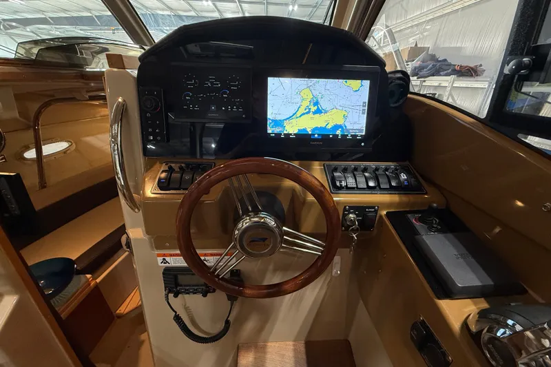 Slide: The Image of Interior helm of 2016 Cutwater C-24 boat with navigation display and controls. - 34