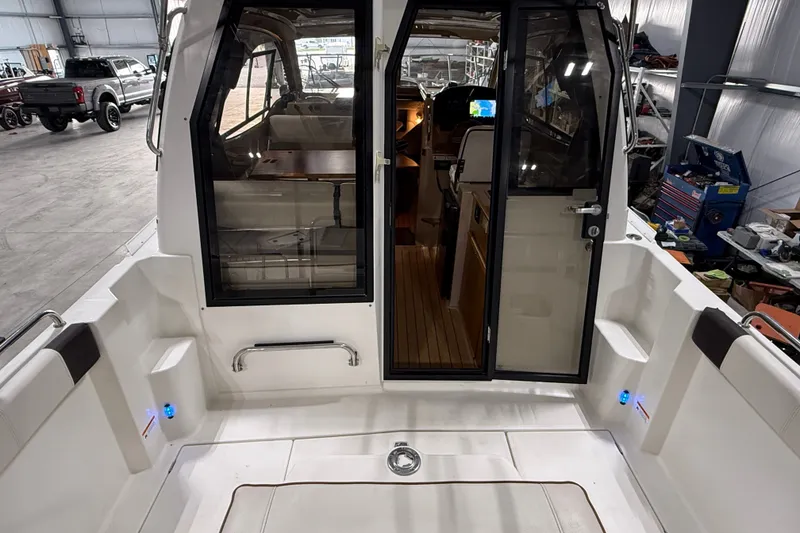 Slide: The Image of 2016 Cutwater C-24 boat interior with cockpit view, showcasing seating and navigation area. - 13