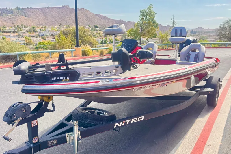 Slide: The Image of 2018 Nitro Z18 fishing boat with Minn Kota Ultrex motor on trailer, scenic background. - 3