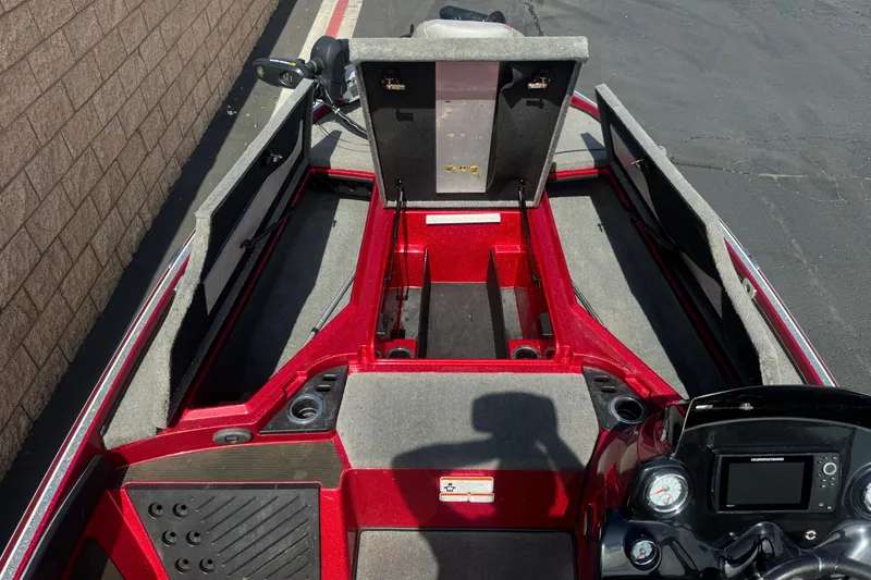 Slide: The Image of 2018 Nitro Z18 boat interior with open storage compartments and control panel. - 12