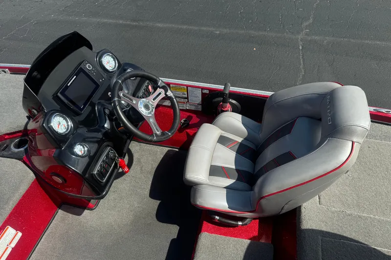 Slide: The Image of 2018 Nitro Z18 boat cockpit with steering wheel and cushioned seat. - 21