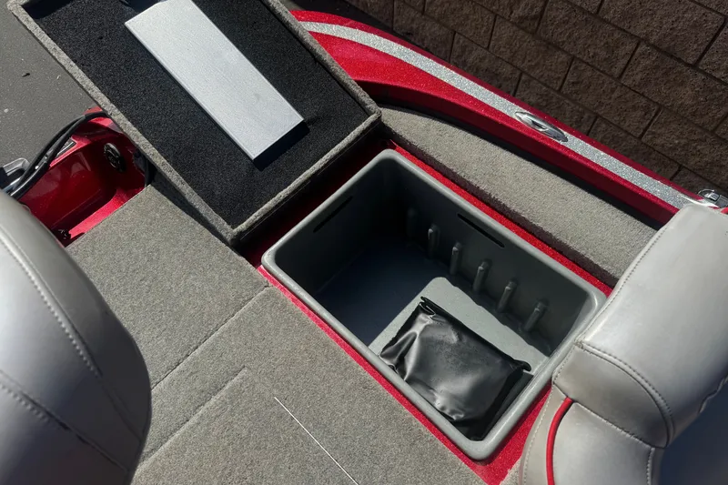 Slide: The Image of Open storage compartment in a 2018 Nitro Z18 boat, featuring gray interior and red exterior. - 17