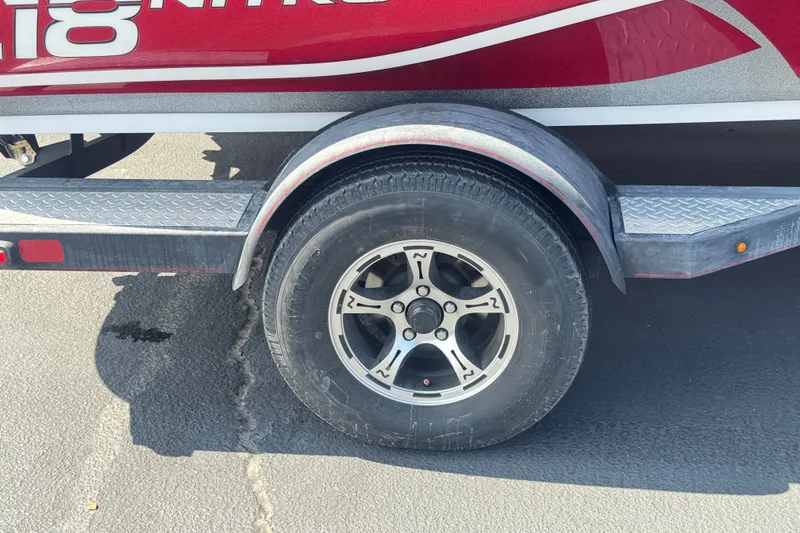 Slide: The Image of Trailer wheel of a 2018 Nitro Z18 boat on asphalt pavement. - 25