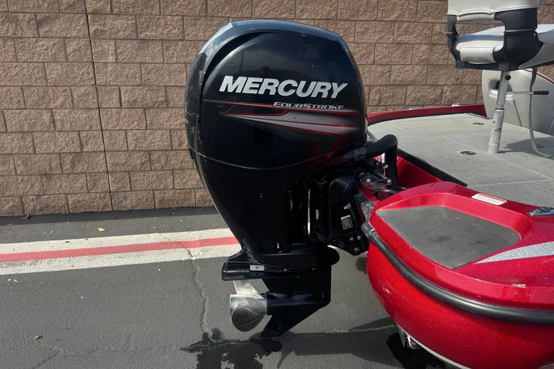 Slide: The Image of Red Nitro Z18 boat with Mercury FourStroke engine, 2018 model, parked on pavement. - 6