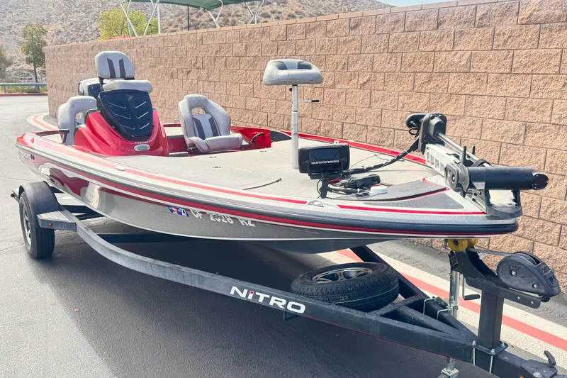 Slide: The Image of 2018 Nitro Z18 fishing boat on trailer, parked near brick wall. - 1