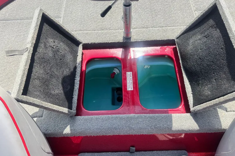 Slide: The Image of Open storage compartments on a 2018 Nitro Z18 boat, featuring carpeted lids and interior. - 16
