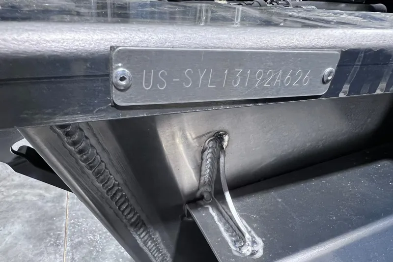 Slide: The Image of Close-up of a 2026 Sylvan R-22 CLZ DH boat hull identification number plate. - 18