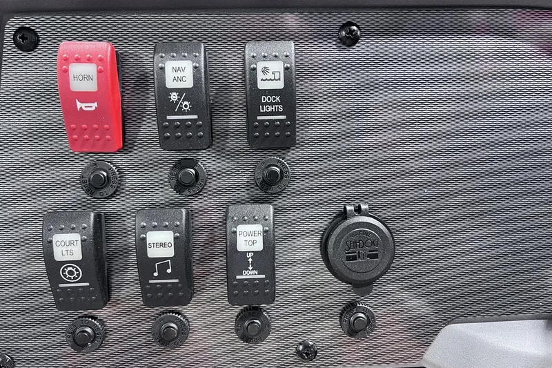 Slide: The Image of Control panel of 2026 Sylvan R-22 CLZ DH boat with various switches and buttons. - 14