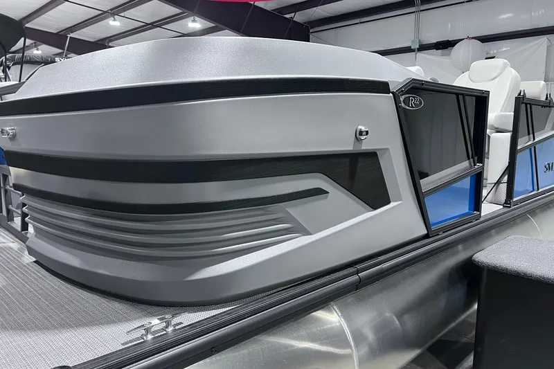 Slide: The Image of 2026 Sylvan R-22 CLZ DH pontoon boat in showroom, showcasing sleek design and modern features. - 1