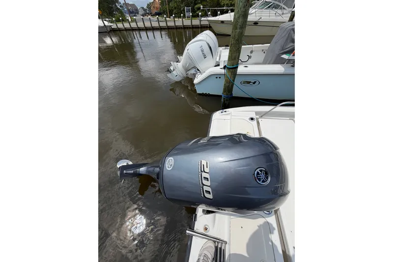 Slide: The Image of Boston Whaler 220 Dauntless 2001 with Yamaha outboard motor docked by the water. - 4