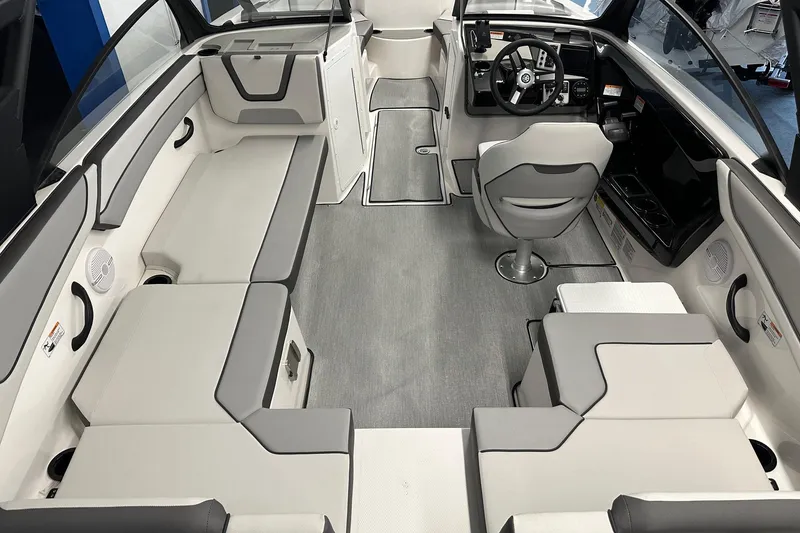 Slide: The Image of 2026 Yamaha Boats AR220 interior with modern seating and sleek steering console. - 4