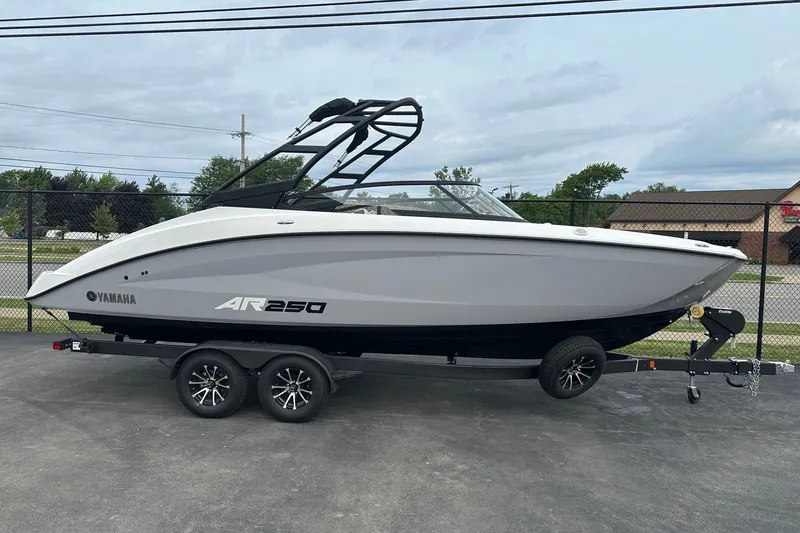 Slide: The Image of 2026 Yamaha Boats AR250 on trailer, sleek design, parked outdoors. - 1