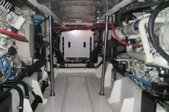 Slide: The Image of Engine room of 2000 Bayliner 4788 Pilot House Motoryacht, showcasing mechanical components and wiring. - 11