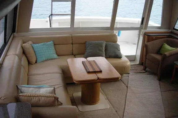 Slide: The Image of Luxurious interior of 2000 Bayliner 4788 Pilot House Motoryacht with cozy seating and table. - 10