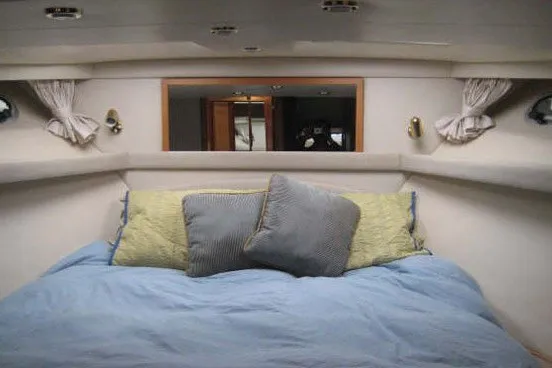 Slide: The Image of Cozy bedroom interior of 2000 Bayliner 4788 Pilot House Motoryacht with plush bedding. - 6