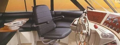 Slide: The Image of Interior view of a 2000 Bayliner 4788 pilothouse with steering wheel and seat. - 4