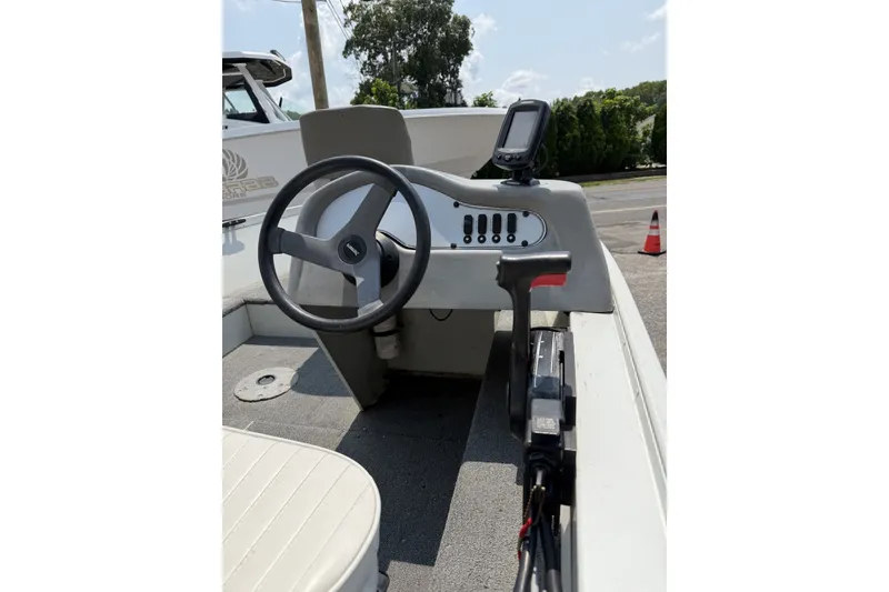 Slide: The Image of 2010 Alumacraft Fisherman 160 CS boat console with steering wheel and control panel. - 6