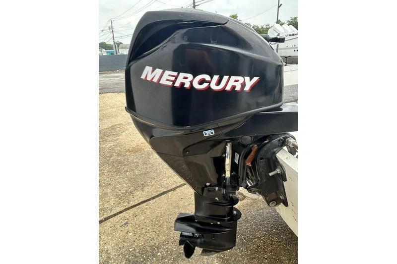 Slide: The Image of Mercury outboard motor on 2010 Alumacraft Fisherman 160 CS boat, parked on concrete. - 11