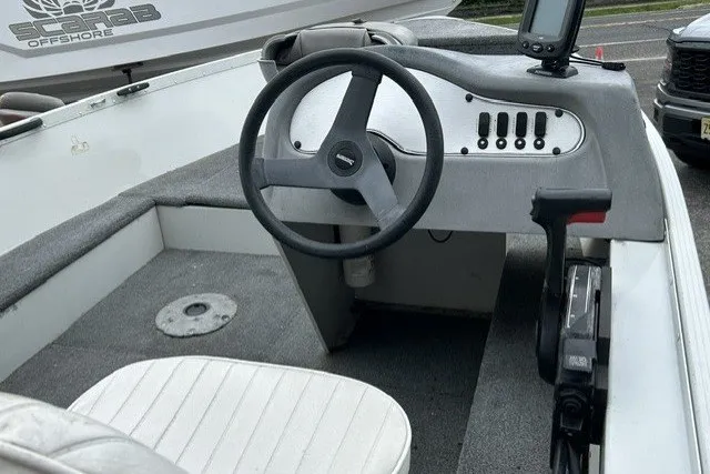 Slide: The Image of 2010 Alumacraft Fisherman 160 CS boat interior with steering wheel and control panel. - 7