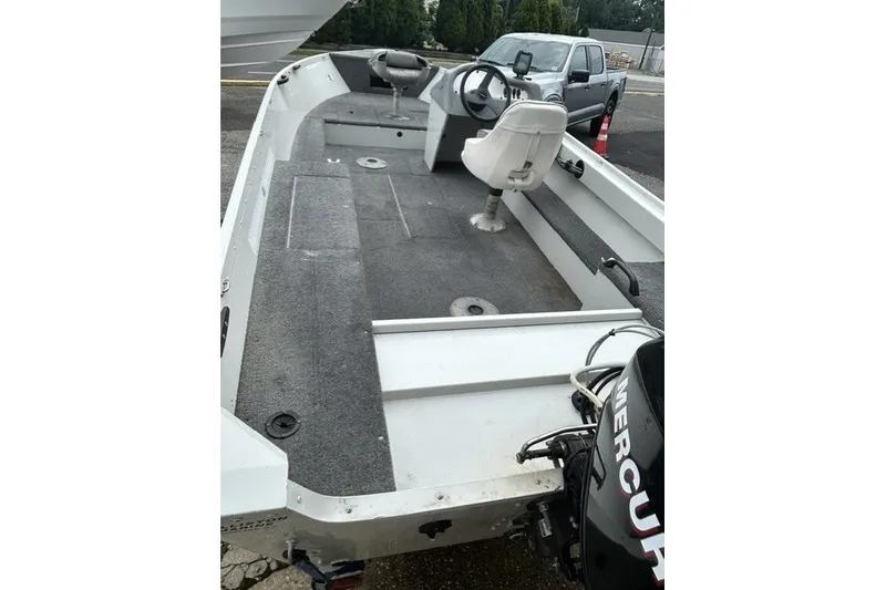 Slide: The Image of 2010 Alumacraft Fisherman 160 CS boat with Mercury outboard motor, featuring spacious interior and seating. - 5