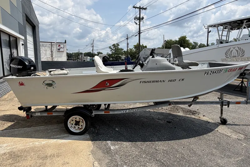 Slide: The Image of 2010 Alumacraft Fisherman 160 CS boat on trailer, parked outdoors. - 1