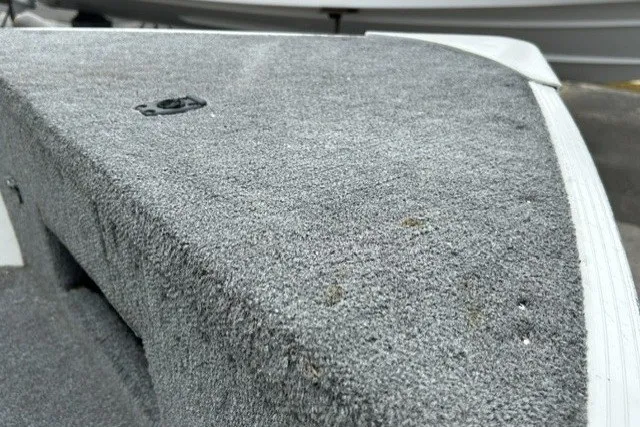 Slide: The Image of 2010 Alumacraft Fisherman 160 CS boat deck with gray carpeted surface. - 10