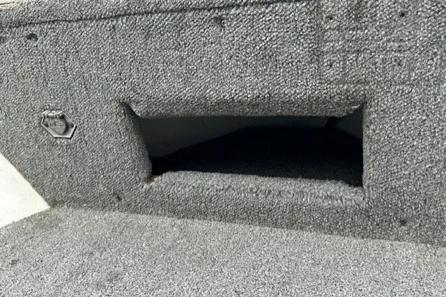 Slide: The Image of 2010 Alumacraft Fisherman 160 CS boat interior with carpeted storage compartment. - 9