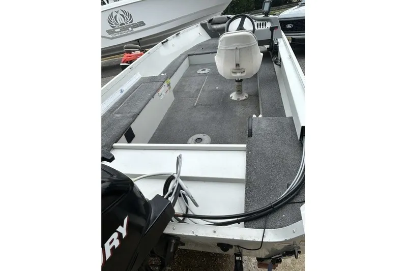 Slide: The Image of 2010 Alumacraft Fisherman 160 CS boat interior with seating and steering console. - 4